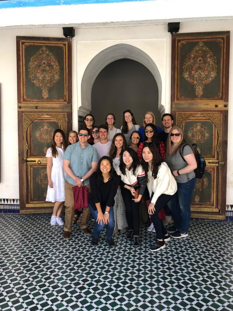 A group of Northwestern Pritzker Law students in front of an arched doorway in Morocco.