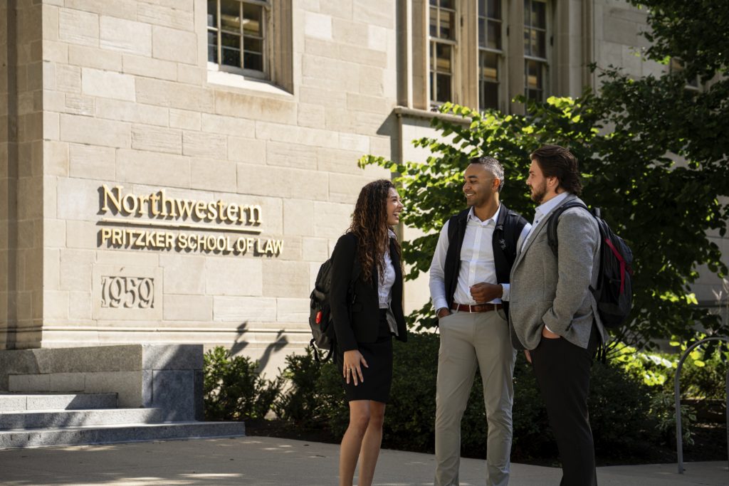 Three students standing outside McCormick Hall at Northwestern Pritzker School of Law.