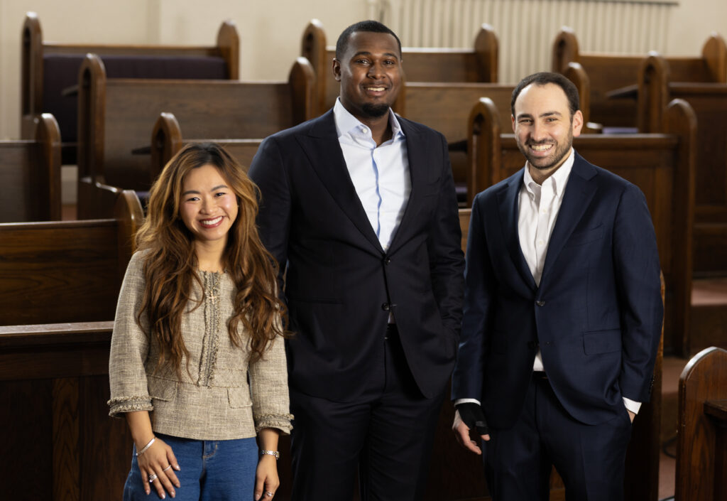 A photo of three JD-MBA students standing in Lincoln Hall: Tram Nguyen, KeVohn McMahon, and Mack Krell